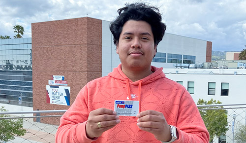 Student holding a pump pass card